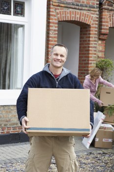 Removal team lifting and handling furniture safely during a move